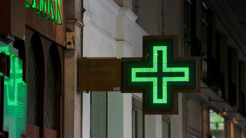 Street view of pharmacy sign in Paris.